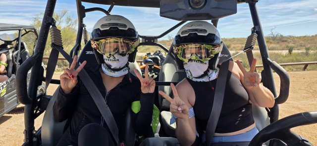 Peace signs from the cockpit of a combo-tour UTV