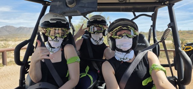 Three friends riding together in one UTV - passengers welcome on the combo tour
