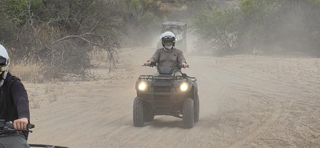 Headlights on and dust flying - solo ATV action on the trail
