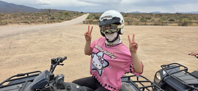 Peace out from a guest driving her own ATV on a 360 Adventures solo tour