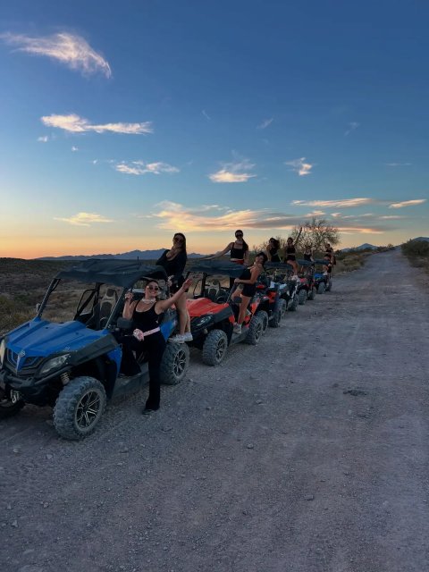 Sand buggies and riders lined up at dusk in the Sonoran Desert
