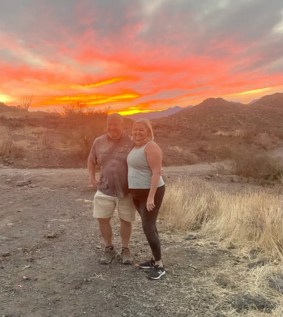 A couple at a fiery sunset on a Scottsdale desert tour
