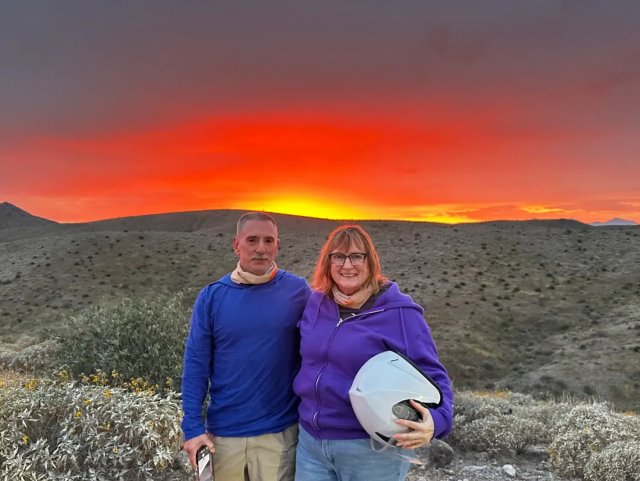 Riders at sunset over the mountains in the Sonoran Desert