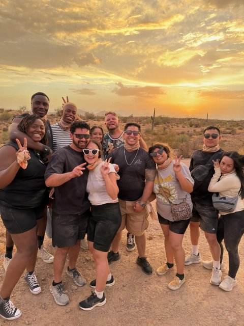 Tour group celebrating at sunset in the Scottsdale desert