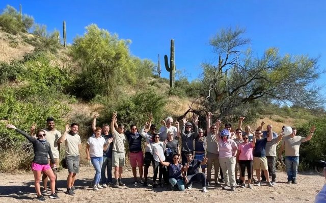 Large group celebrating among saguaros on a Scottsdale desert tour