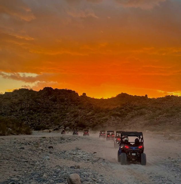 Sand buggy against a dramatic orange Sonoran Desert sunset