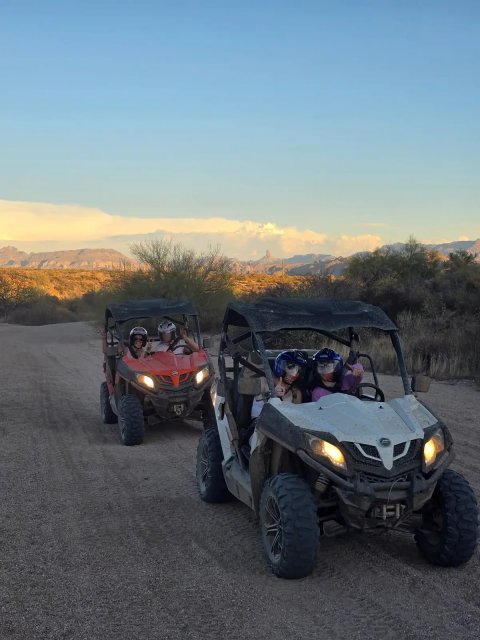 Two UTVs on a desert trail during golden hour